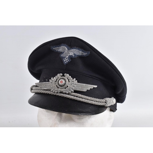 365 - WWII STYLE LUFTWAFFE PEAKED CAP, this is navy blue in colour and has silver rope style decoration an... 