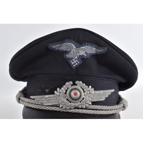 365 - WWII STYLE LUFTWAFFE PEAKED CAP, this is navy blue in colour and has silver rope style decoration an... 