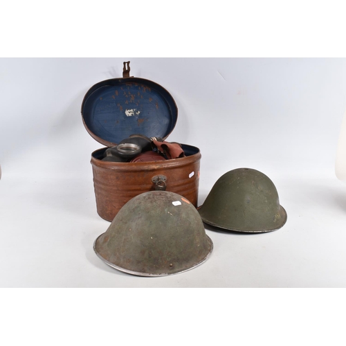 367 - TWO BRITISH STEEL HELMETS AND FOUR WWII ERA GAS MASKS INCLUDING a Mickey Mouse gas mask, this collec... 