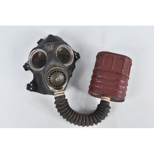 367 - TWO BRITISH STEEL HELMETS AND FOUR WWII ERA GAS MASKS INCLUDING a Mickey Mouse gas mask, this collec... 