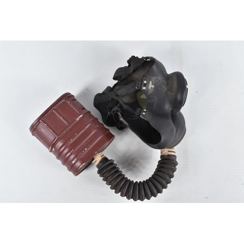 367 - TWO BRITISH STEEL HELMETS AND FOUR WWII ERA GAS MASKS INCLUDING a Mickey Mouse gas mask, this collec... 