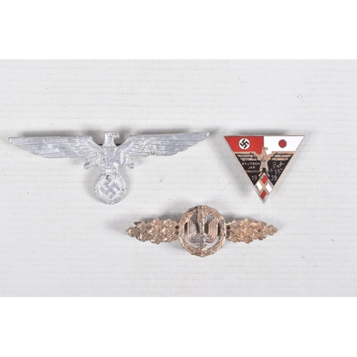 375 - THREE GERMAN BADGES, to include a short range bomber clasp, a metal clasp eagle and Germany-Japan al... 