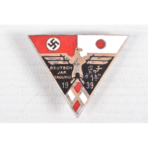 375 - THREE GERMAN BADGES, to include a short range bomber clasp, a metal clasp eagle and Germany-Japan al... 