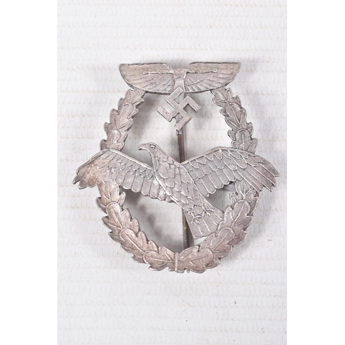 382 - THREE GERMAN AWARD BADGES, to include a NSFK pilots badge for pavered aircraft, a KRiegsmarine auxil... 