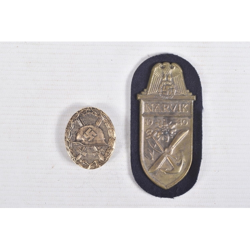 384 - A GOLD GERMAN WOUND BADGE AND A NARVIK SHIELD, the wound badge has a vertical pin on the rear but no... 