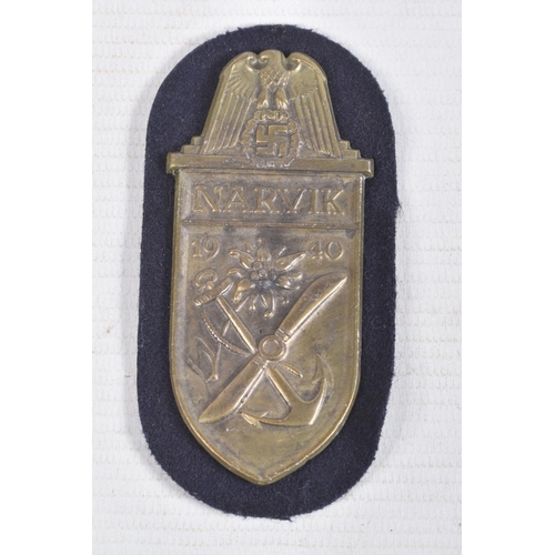 384 - A GOLD GERMAN WOUND BADGE AND A NARVIK SHIELD, the wound badge has a vertical pin on the rear but no... 