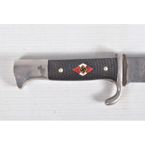 387 - A GERMAN HJ KNIFE IN ITS ORIGINAL SCABBARD, the motto Blut Und Ehre is on one side and the other sid... 