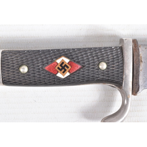 387 - A GERMAN HJ KNIFE IN ITS ORIGINAL SCABBARD, the motto Blut Und Ehre is on one side and the other sid... 