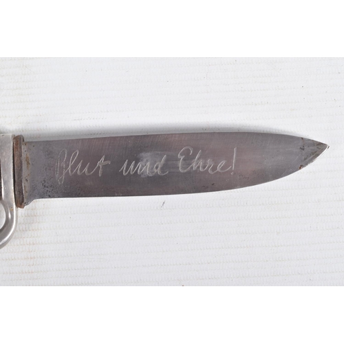 387 - A GERMAN HJ KNIFE IN ITS ORIGINAL SCABBARD, the motto Blut Und Ehre is on one side and the other sid... 