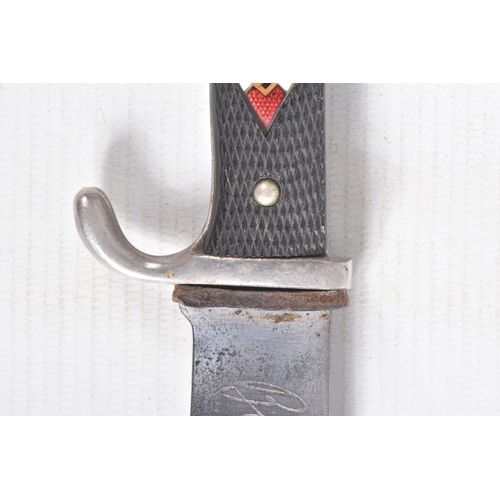 387 - A GERMAN HJ KNIFE IN ITS ORIGINAL SCABBARD, the motto Blut Und Ehre is on one side and the other sid... 