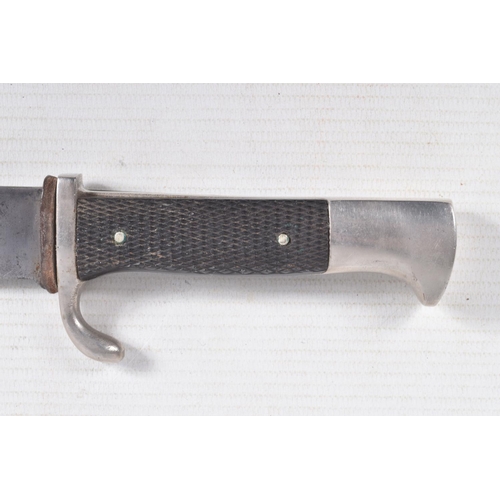 387 - A GERMAN HJ KNIFE IN ITS ORIGINAL SCABBARD, the motto Blut Und Ehre is on one side and the other sid... 