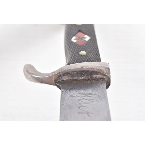 387 - A GERMAN HJ KNIFE IN ITS ORIGINAL SCABBARD, the motto Blut Und Ehre is on one side and the other sid... 