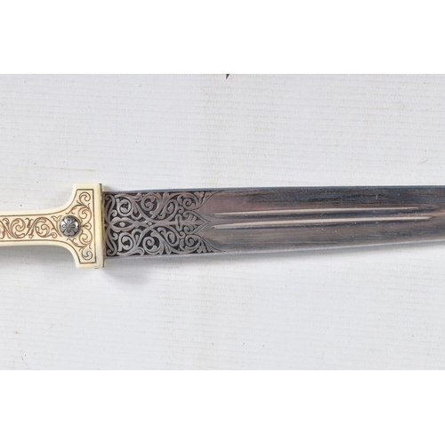 397 - A DECORATIVE DAGGER WITH A CARVED HANDLE WITH EMBOSSED BLADE, this comes in a metal banded leather s... 