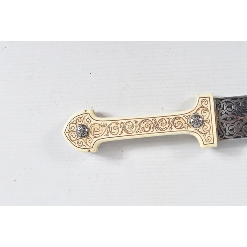 397 - A DECORATIVE DAGGER WITH A CARVED HANDLE WITH EMBOSSED BLADE, this comes in a metal banded leather s... 