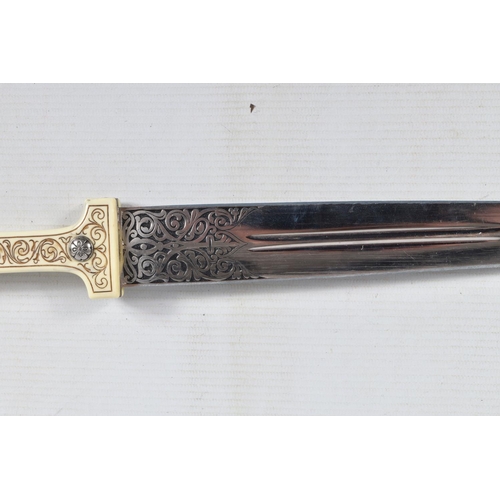 397 - A DECORATIVE DAGGER WITH A CARVED HANDLE WITH EMBOSSED BLADE, this comes in a metal banded leather s... 