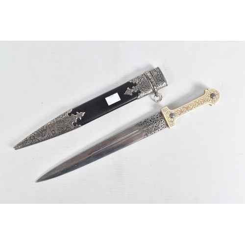 397 - A DECORATIVE DAGGER WITH A CARVED HANDLE WITH EMBOSSED BLADE, this comes in a metal banded leather s... 