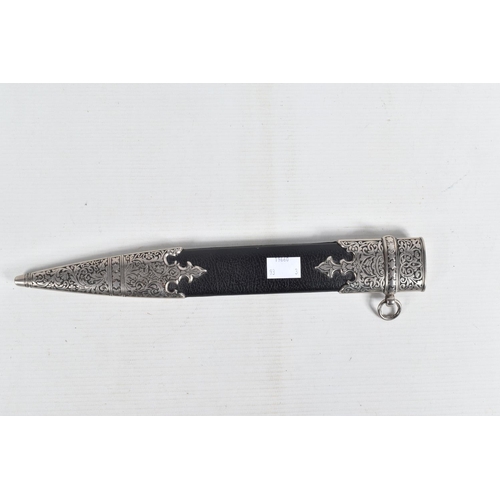 397 - A DECORATIVE DAGGER WITH A CARVED HANDLE WITH EMBOSSED BLADE, this comes in a metal banded leather s... 