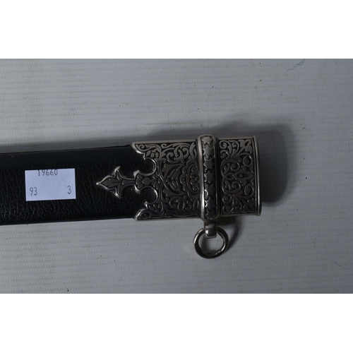 397 - A DECORATIVE DAGGER WITH A CARVED HANDLE WITH EMBOSSED BLADE, this comes in a metal banded leather s... 