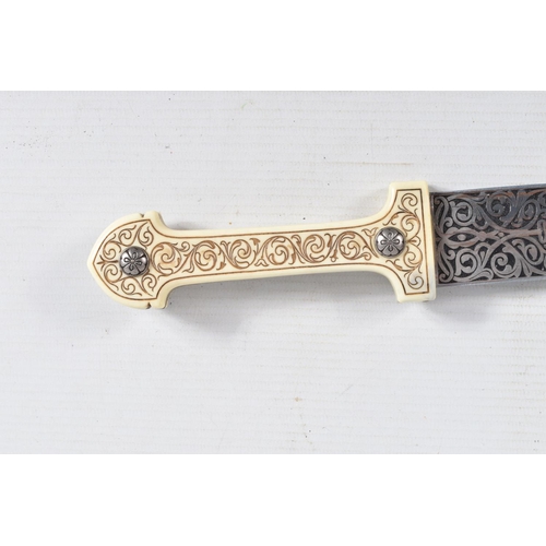 397 - A DECORATIVE DAGGER WITH A CARVED HANDLE WITH EMBOSSED BLADE, this comes in a metal banded leather s... 