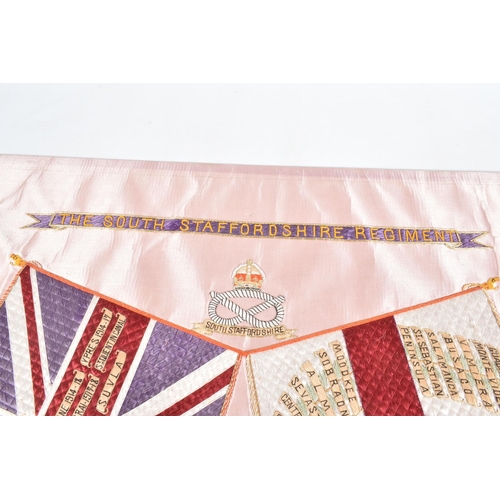 406 - A SOUTH STAFFORDSHIRE REGIMENT EMBROIDERY MOUNTED TO A BOARD, this features the regimental crest and... 