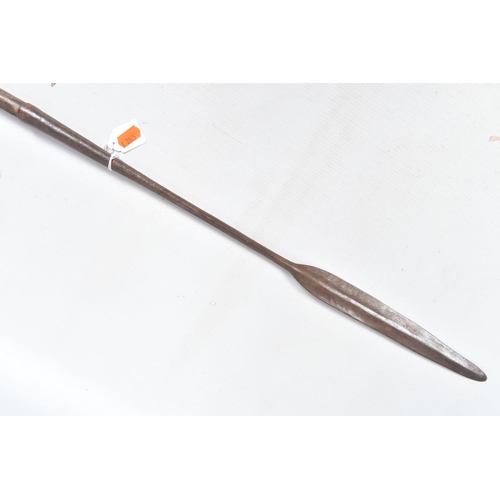 410 - THREE TRIBAL HUNTING SPEARS, the first features a wooden shaft and a grooved arrow shaped steel tip,... 