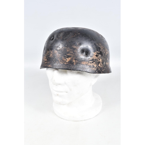 412 - A WWII RELIC OF A GERMAN HELMET, this appears to be a Fallschirmjager or Paratroopers helmet, the ve... 