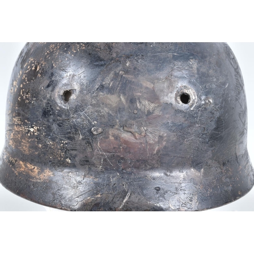 412 - A WWII RELIC OF A GERMAN HELMET, this appears to be a Fallschirmjager or Paratroopers helmet, the ve... 