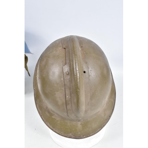 415 - A WWII ERA POLICE STEEL HELMET AND THREE OTHERS, the blue police helmet has a liner and chinestrap s... 