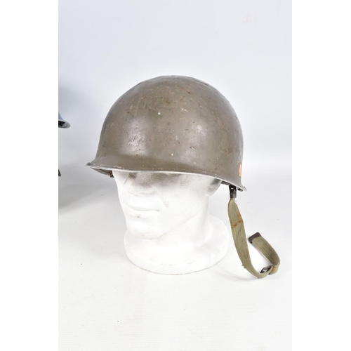 415 - A WWII ERA POLICE STEEL HELMET AND THREE OTHERS, the blue police helmet has a liner and chinestrap s... 