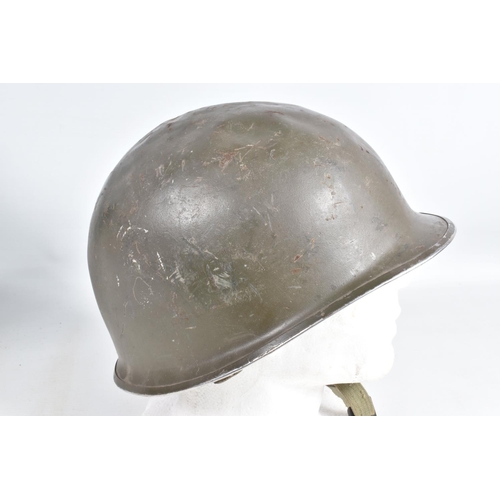 415 - A WWII ERA POLICE STEEL HELMET AND THREE OTHERS, the blue police helmet has a liner and chinestrap s... 