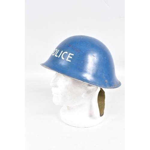 415 - A WWII ERA POLICE STEEL HELMET AND THREE OTHERS, the blue police helmet has a liner and chinestrap s... 