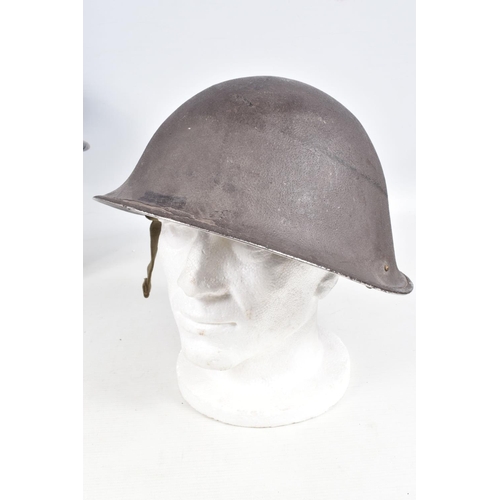 415 - A WWII ERA POLICE STEEL HELMET AND THREE OTHERS, the blue police helmet has a liner and chinestrap s... 