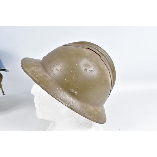 415 - A WWII ERA POLICE STEEL HELMET AND THREE OTHERS, the blue police helmet has a liner and chinestrap s... 