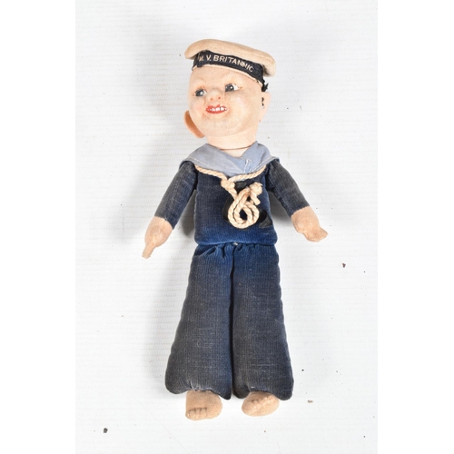 416 - A VINTAGE NORA WELLINGS SAILOR DOLL, a leather belt with a collection of cap and collar badges on it... 