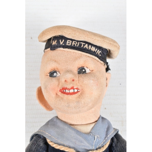 416 - A VINTAGE NORA WELLINGS SAILOR DOLL, a leather belt with a collection of cap and collar badges on it... 