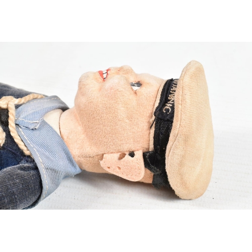 416 - A VINTAGE NORA WELLINGS SAILOR DOLL, a leather belt with a collection of cap and collar badges on it... 