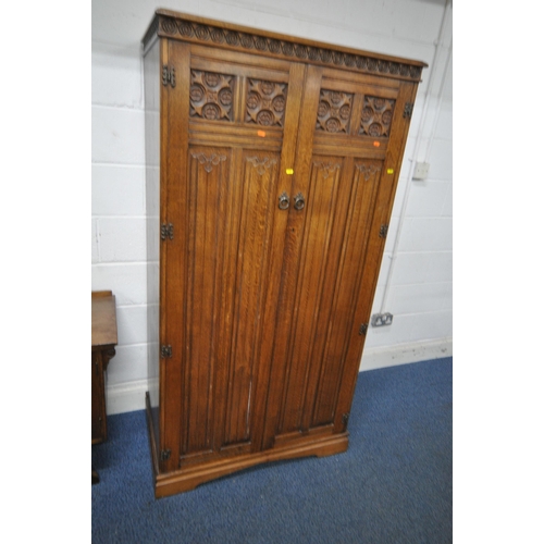 1207 - AN EARLY 20TH CENTURY OAK DOUBLE DOOR WARDROBE, with quatrefoil and linenfold design, width 130cm x ... 