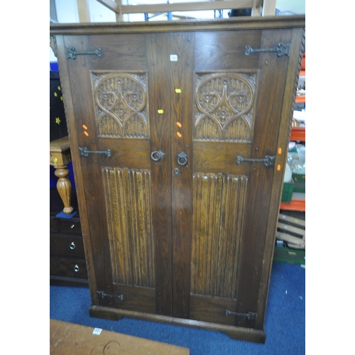 1207 - AN EARLY 20TH CENTURY OAK DOUBLE DOOR WARDROBE, with quatrefoil and linenfold design, width 130cm x ... 