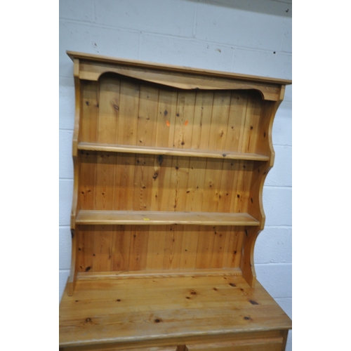 1209 - A MODERN PINE DRESSER, the two tier plate rack, atop a base with two drawers, above double cupboard ... 