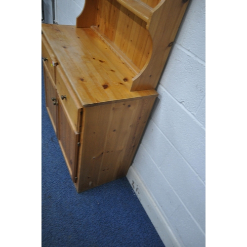 1209 - A MODERN PINE DRESSER, the two tier plate rack, atop a base with two drawers, above double cupboard ... 