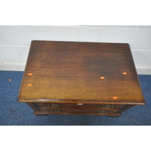 1213 - TITCHMARSH AND GOODWIN, A GOOD QUALITY REPRODUCTION OAK TV CABINET, with a fall front door and singl... 