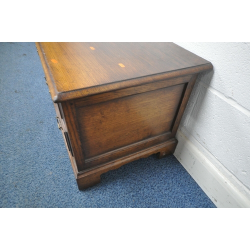 1213 - TITCHMARSH AND GOODWIN, A GOOD QUALITY REPRODUCTION OAK TV CABINET, with a fall front door and singl... 