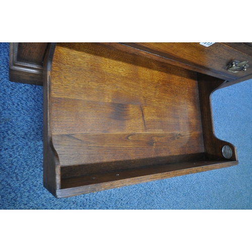 1213 - TITCHMARSH AND GOODWIN, A GOOD QUALITY REPRODUCTION OAK TV CABINET, with a fall front door and singl... 