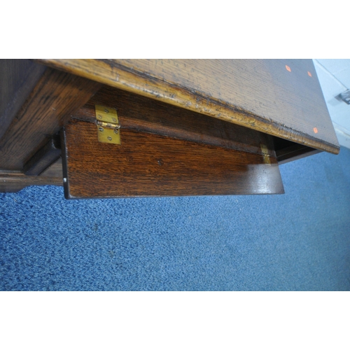 1213 - TITCHMARSH AND GOODWIN, A GOOD QUALITY REPRODUCTION OAK TV CABINET, with a fall front door and singl... 