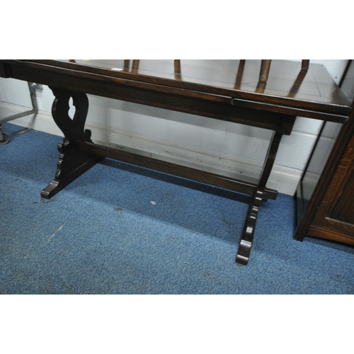 1220 - AN EARLY 20TH CENTURY OAK SIX PIECE DINING SUITE, comprising a draw leaf table, raised on trestle le... 