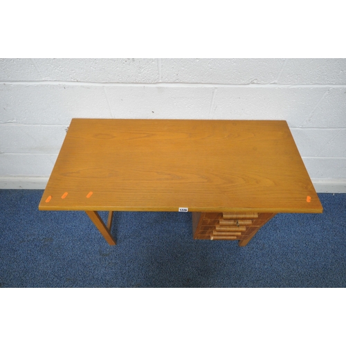 1226 - POSSIBLY HEALS BY GORDON RUSSELL, A MID CENTURY OAK DESK, of small proportions, fitted with five dra... 