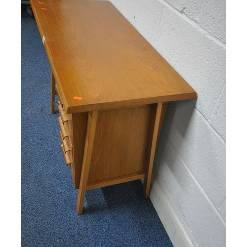 1226 - POSSIBLY HEALS BY GORDON RUSSELL, A MID CENTURY OAK DESK, of small proportions, fitted with five dra... 