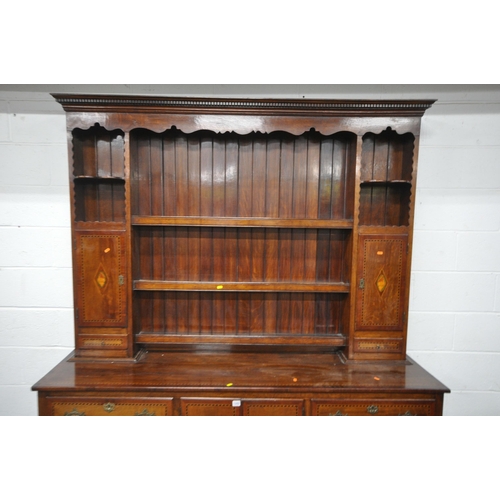 1242 - A GEORGIAN STYLE REPRODUCTION OAK DRESSER, the top fitted with two doors, two drawers, an arrangemen... 