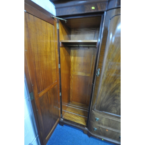 1243 - A REPRODUCTION MAHOGANY COMPACTUM WARDROBE, fitted with double bevelled mirrored doors, flanking a s... 