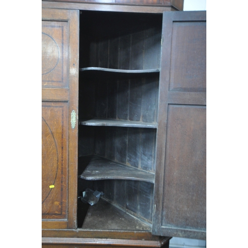 1244 - A LARGE GEORGIAN OAK CORNER CUPBOARD, fitted with four doors, enclosing shelves, width 114cm x depth... 